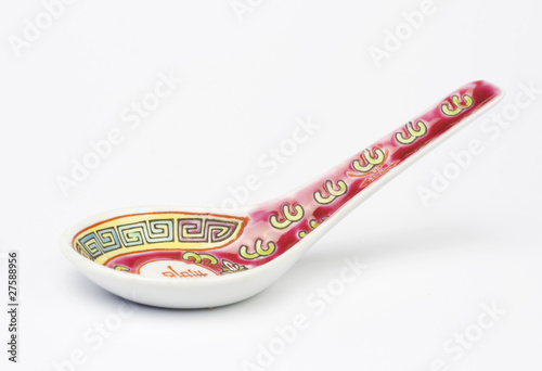 Chinese soup spoon over white background. Studio shot.