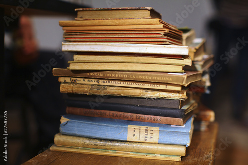 Pile of old literature books stacked on the shelf