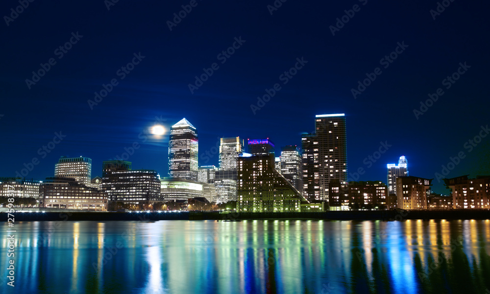 Canary wharf across the Thames at night