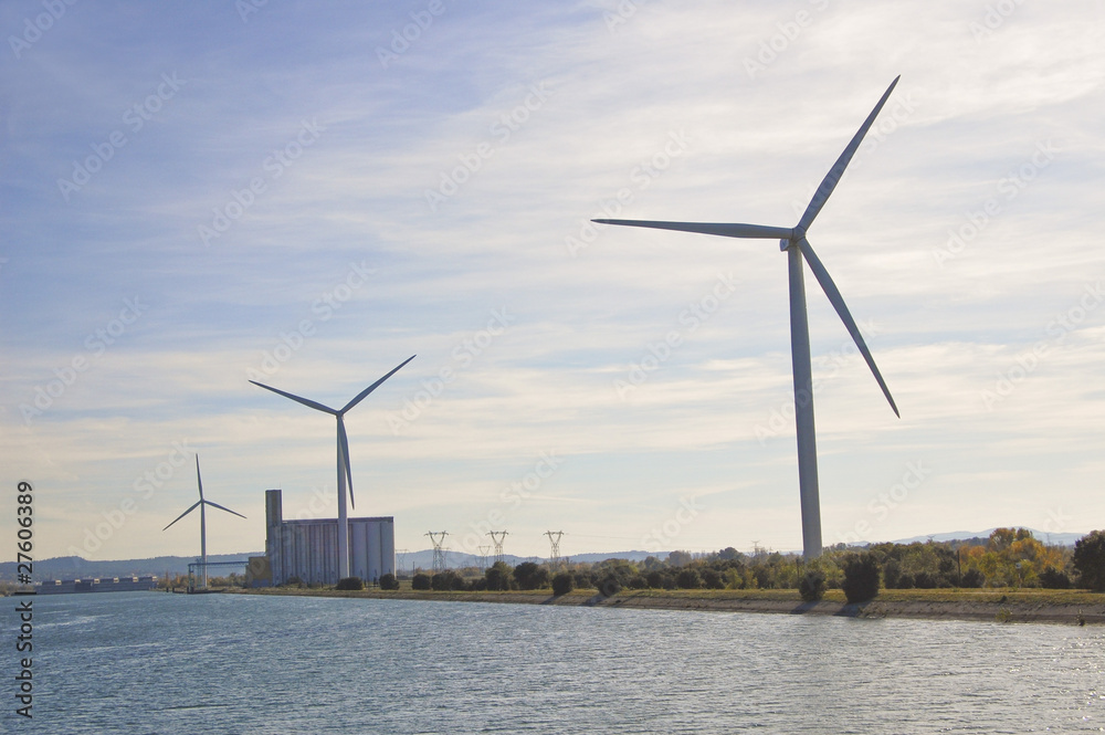 Wind turbines generate electricity along the Rhone river