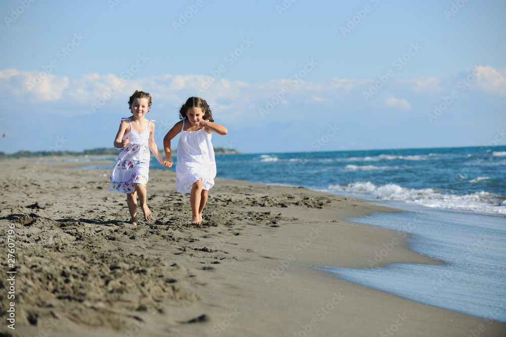 cute little girls running on beach