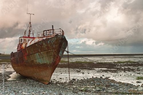 Dead fishing boat on the beach © Radomir Rezny