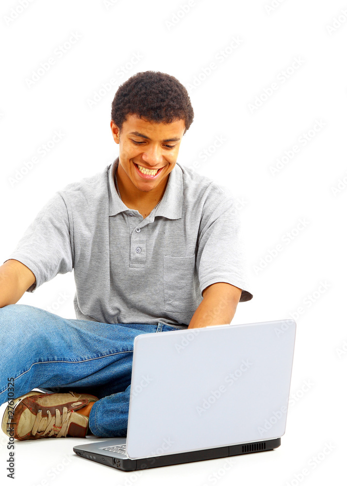 Happy young man working on a laptop, isolated Happy young man working on a laptop, isolated