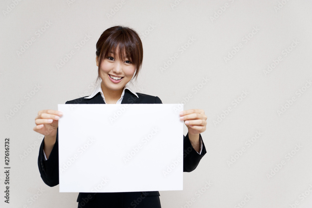 a portrait of young business woman taking a blank white board