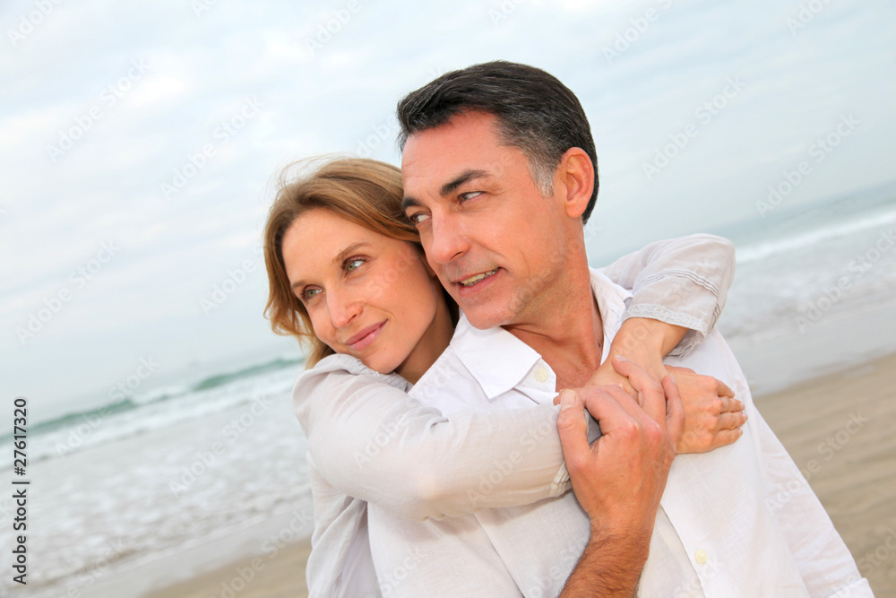 Couple embracing each other at the beach Couple embracing each other at the beach