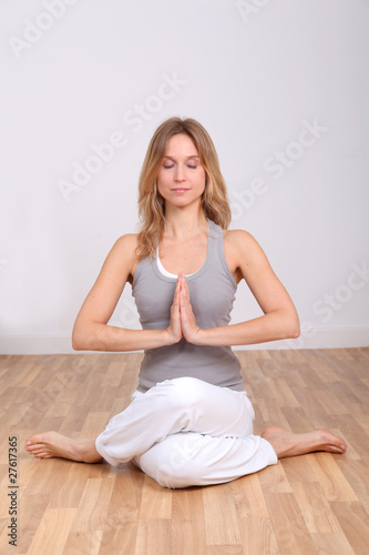 Blond woman doing yoga exercises