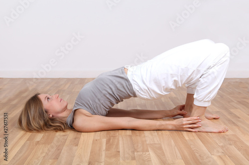 Blond woman doing yoga exercises