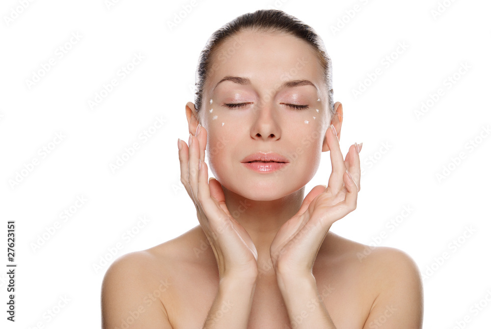 Beautiful sexy woman applying cosmetic cream on skin near eyes Beautiful sexy woman applying cosmetic cream on skin near eyes