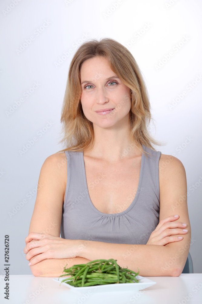 Woman in front of plate of green beans Woman in front of plate of green beans