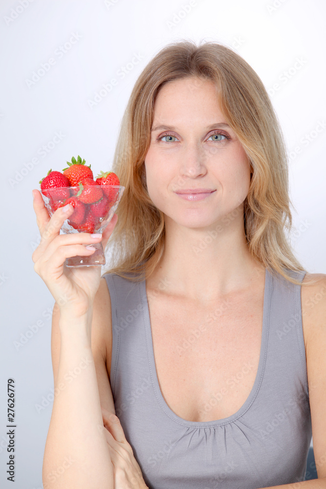 Beautiful blond woman eating strawberries Beautiful blond woman eating strawberries