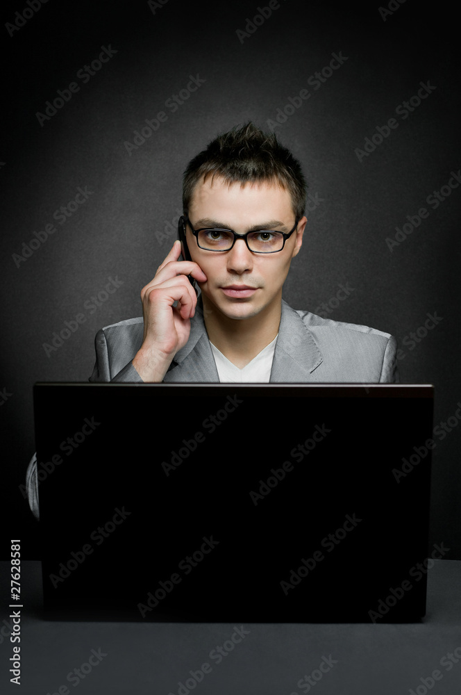 businessman with laptop and mobile phone on black businessman with laptop and mobile phone on black