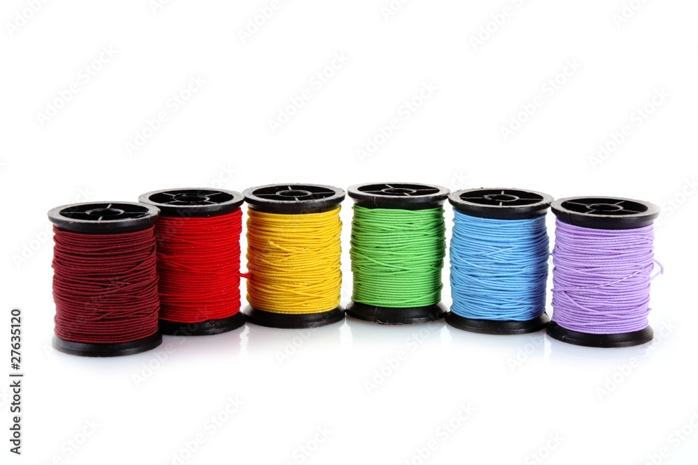 Coloured bobbins of thread isolated on white Coloured bobbins of thread isolated on white