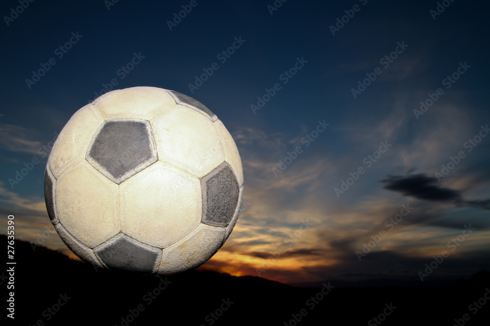 Fototapeta premium soccer ball in sunset