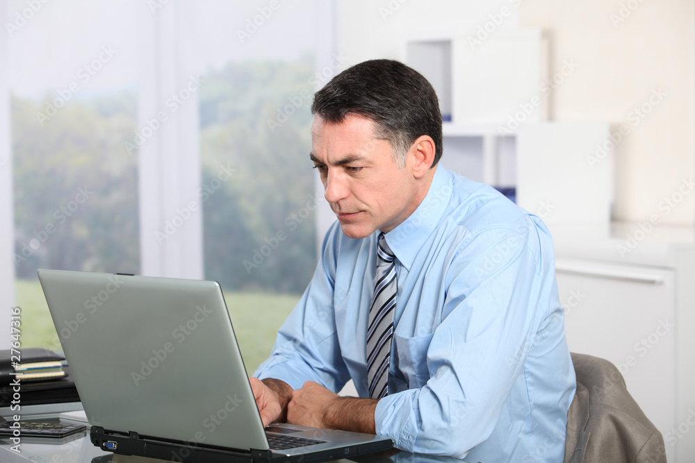 Businessman working on laptop computer Businessman working on laptop computer