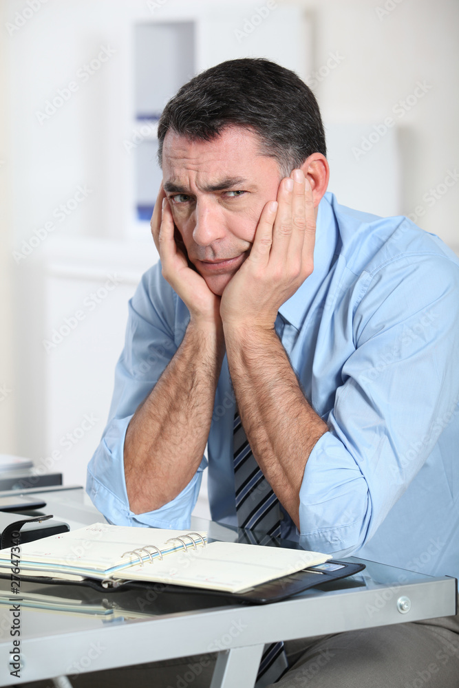 Businessman in the office working hard on project Businessman in the office working hard on project