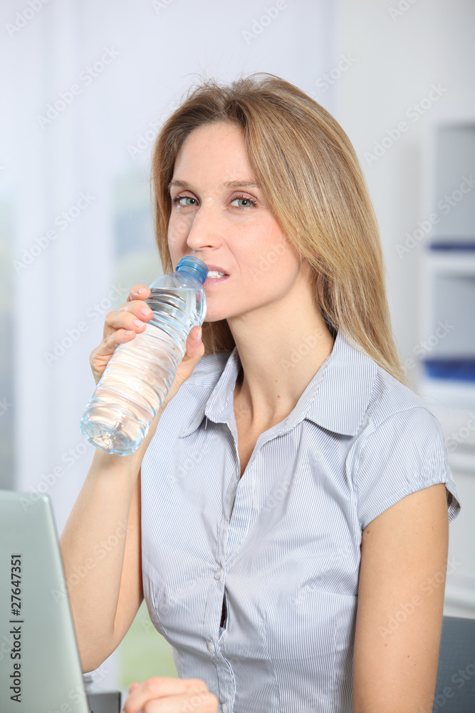 Closeup of beautiful office worker drinking water Closeup of beautiful office worker drinking water