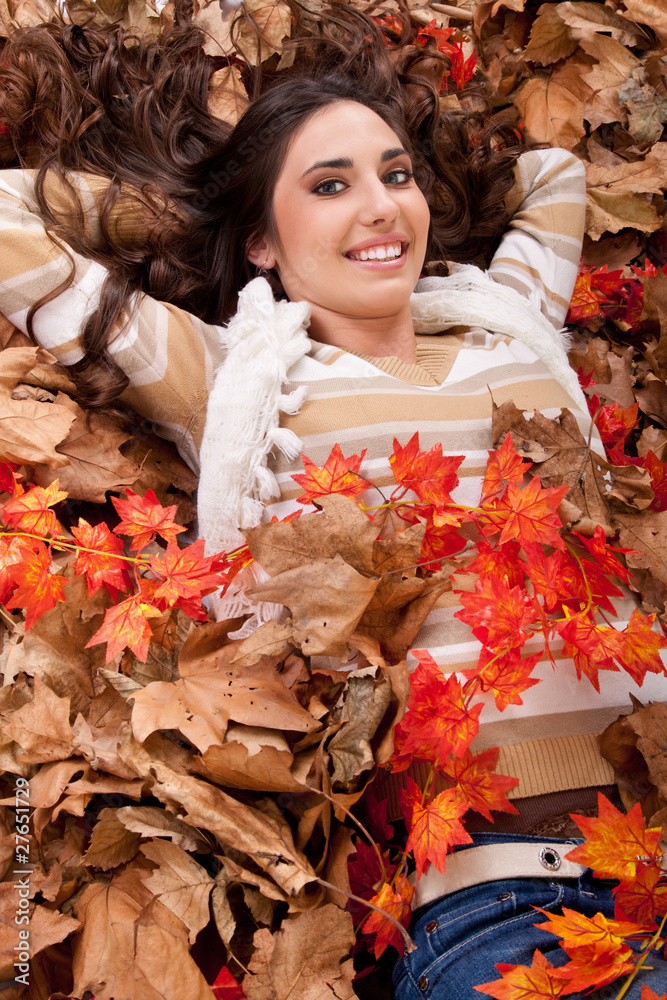 pretty brunette  girl in dry autumn leaves