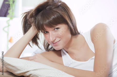 happy woman relaxing in bed