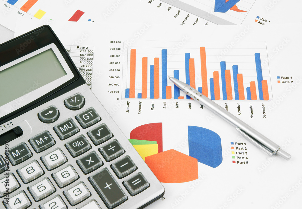 Pen and calculator on paper table with diagram Pen and calculator on paper table with diagram