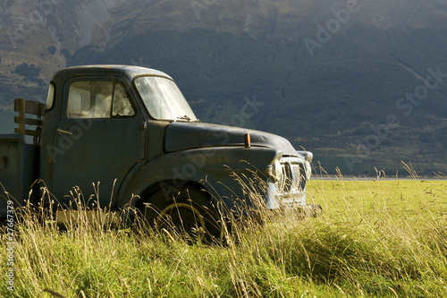 An old pickup truck in a grassy field