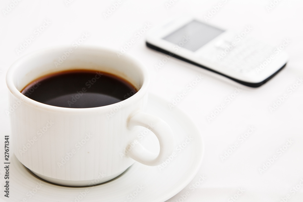 White coffee cup and white mobile phone White coffee cup and white mobile phone