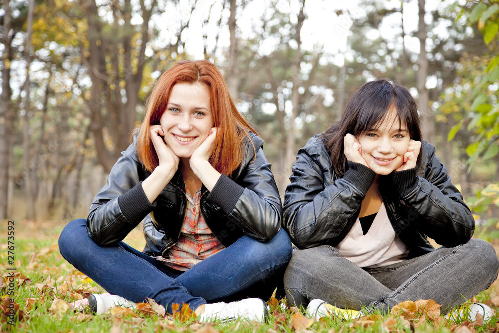 Two girlfriends at the autumn park. Two girlfriends at the autumn park.