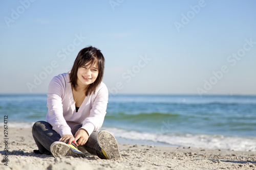 Portrait of brunette girl at the beach. © Masson