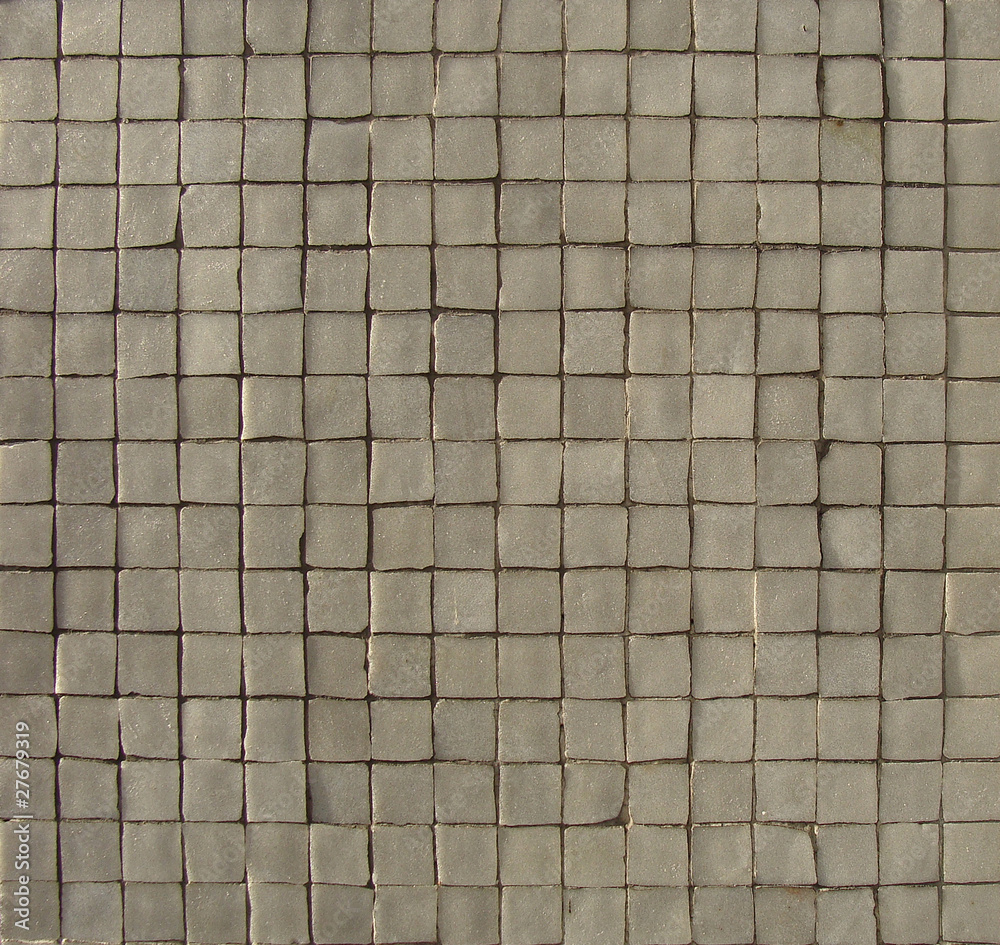 white gray mosaic pattern on a wall with some depth