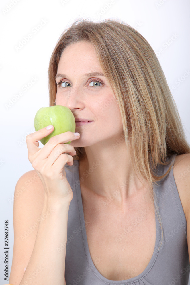 Beautiful blond woman eating green apple Beautiful blond woman eating green apple