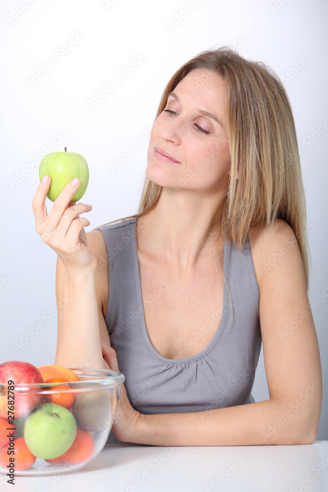 Closeup of beautiful woman holding green apple Closeup of beautiful woman holding green apple