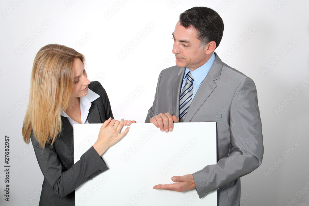 Business team showing white message board Business team showing white message board
