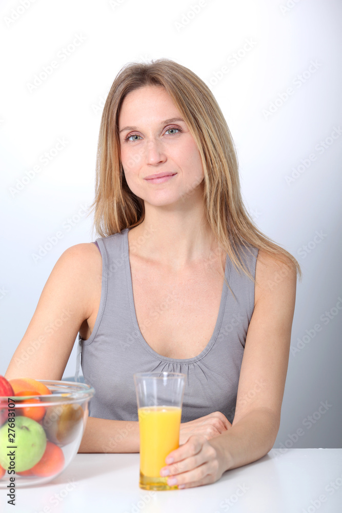 Beautiful blond woman drinking fruit juice Beautiful blond woman drinking fruit juice