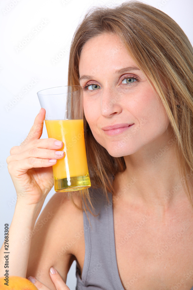 Closeup of beautiful blond woman drinking fruit juice Closeup of beautiful blond woman drinking fruit juice