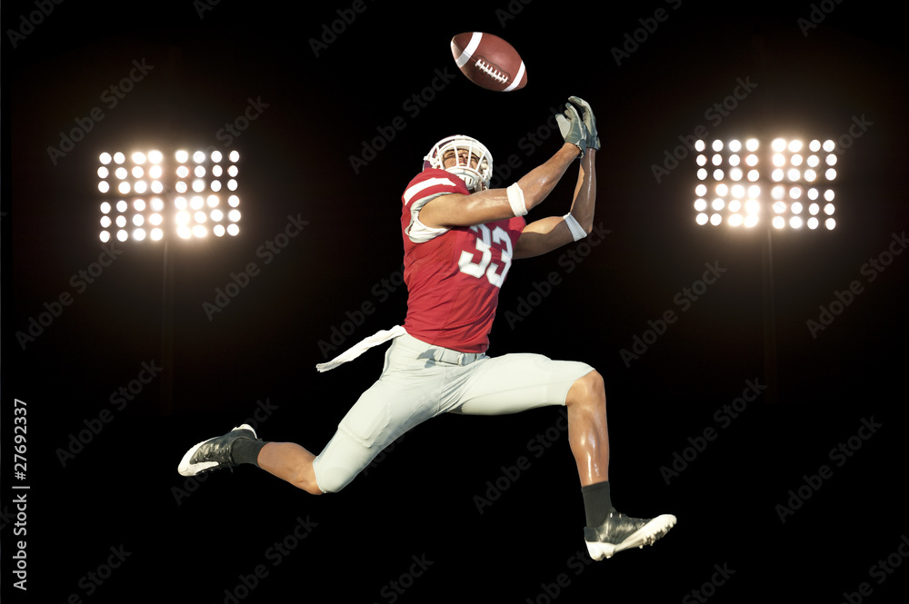 © Pete Saloutos - football player catches ball in midair © Pete Saloutos - football player catches ball in midair