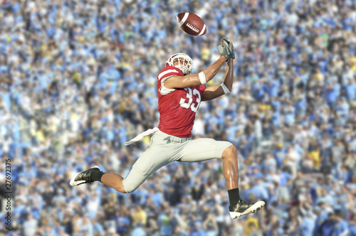 Photography football player catches ball in midair
