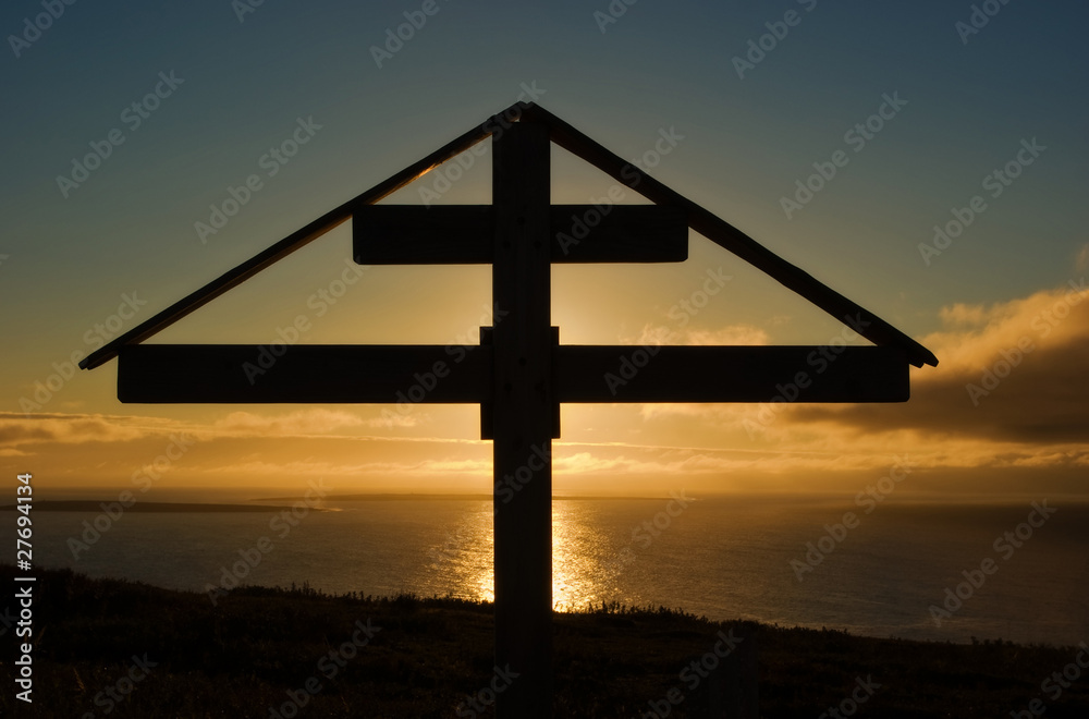 Orthodox cross at sunset over the Arctic Ocean