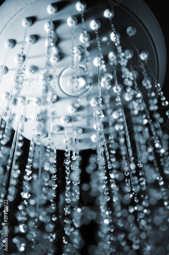 closeup view of water flowing out of shower in dark