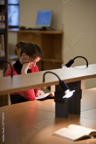 pretty female college student in a college library  shallow DOF 