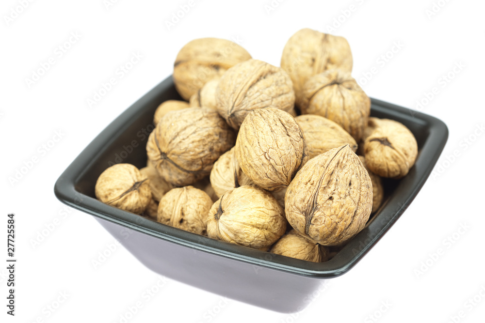 walnuts in a bowl isolated on white walnuts in a bowl isolated on white