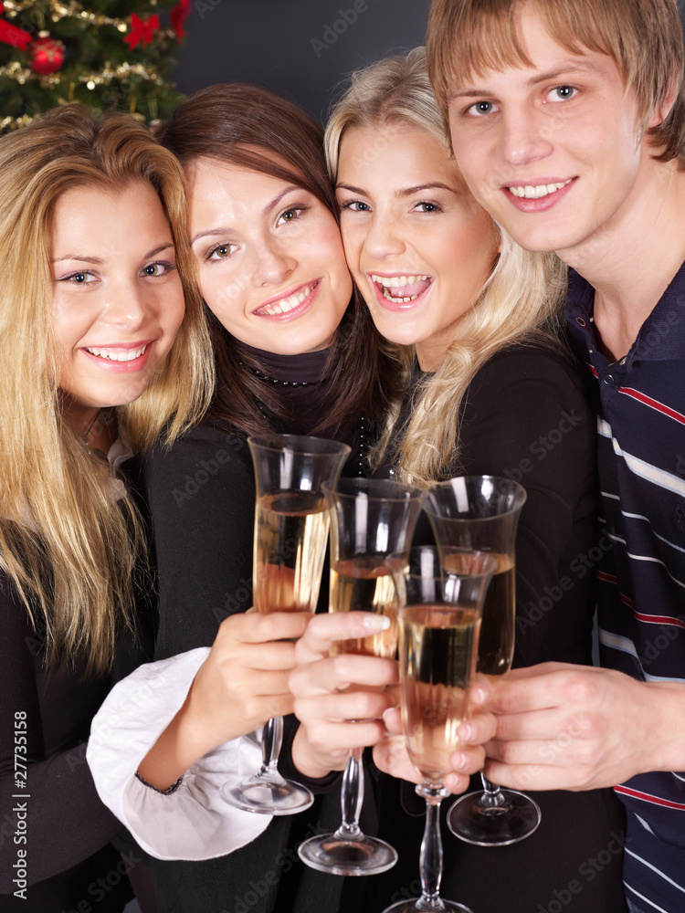 Group young people drinking champagne by christmas tree. Group young people drinking champagne by christmas tree.