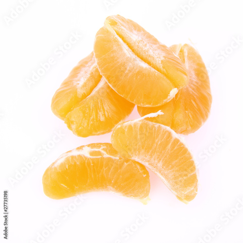 Segments of a peeled mandarin on white background