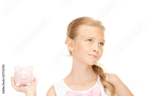 lovely teenage girl with piggy bank