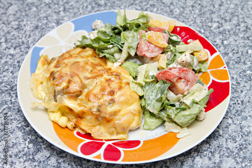 chicken breast baked under cheese with salad
