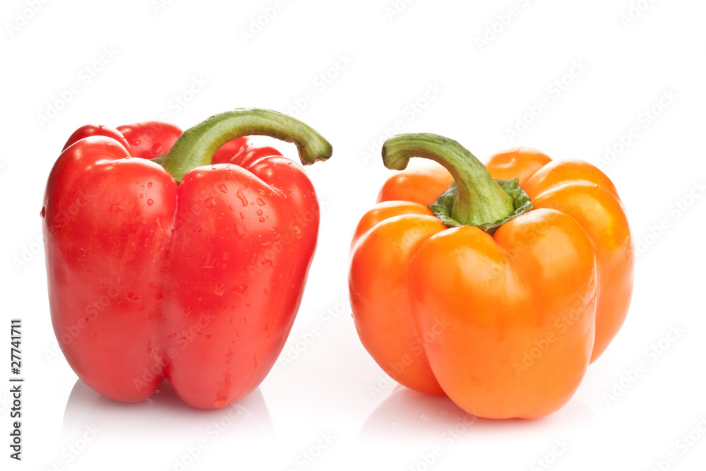 Red and orange paprikas on white background Red and orange paprikas on white background