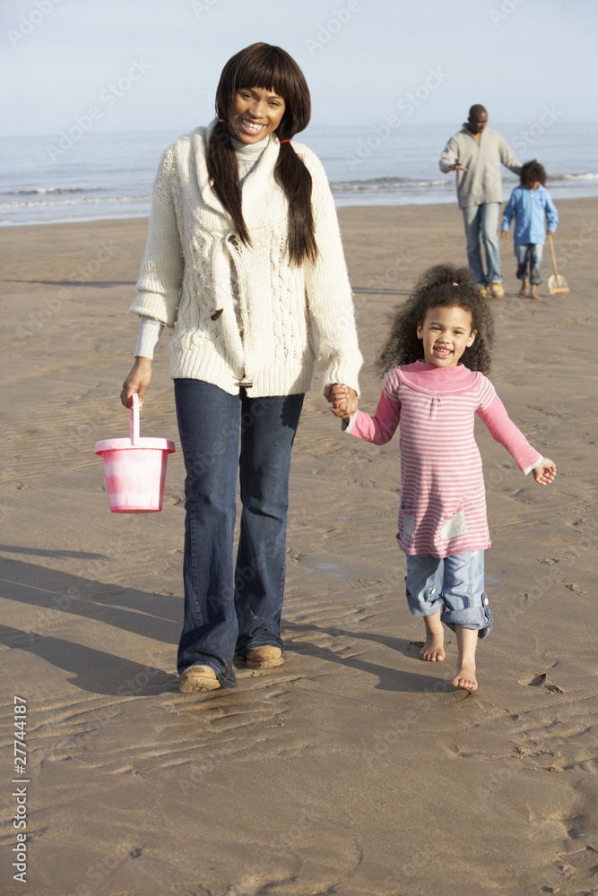 Family Walking By Sea On Winter Beach Family Walking By Sea On Winter Beach