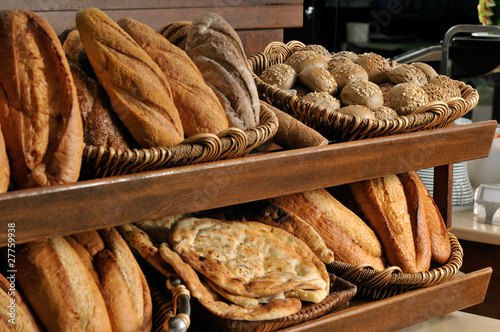 Assortment of baked bread on shelves.