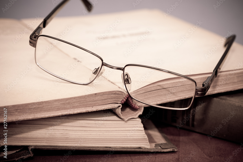 book and glasses in library