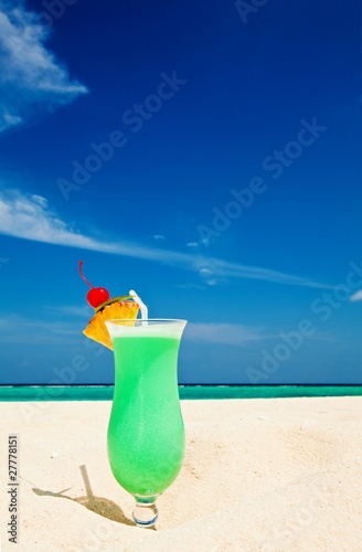 Fruity cocktail is on a beach