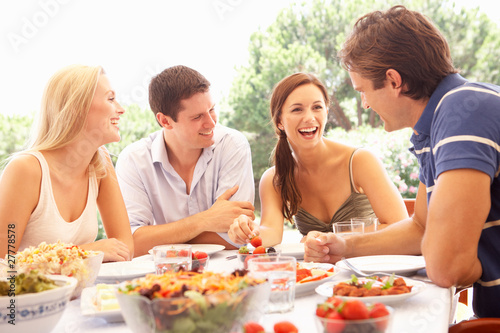 Two young couples eating outdoors