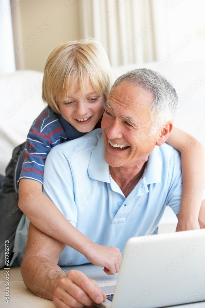 Senior man with young boy using laptop computer Senior man with young boy using laptop computer